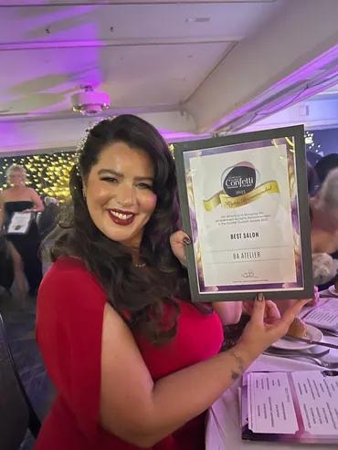 Malinda holding the Confetti Best Salon award