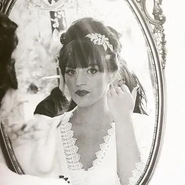 Black and white — bride reflected in ornate mirror